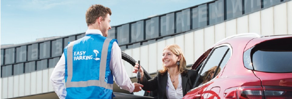 Frau übergibt einem Easy-Parking-Mitarbeiter am Flughafen Wien die Autoschlüssel für den Parkservice.