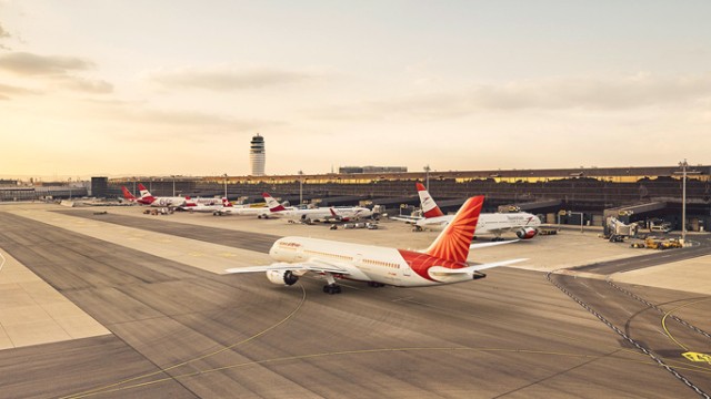 Photo of an airplane with the tower in the background 